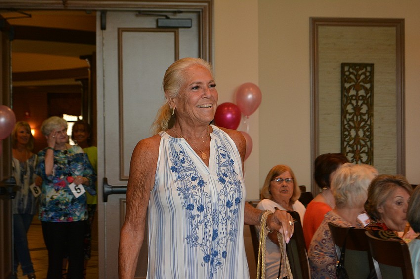 Sandi Eisenberg takes her turn modeling one of four outfits she would wear.