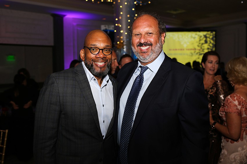 Trevor Harvey and President and CEO Philip Tavill