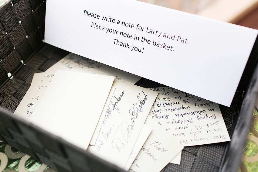 Guests wrote notes for Pat and Larry Thompson during cocktail hour.