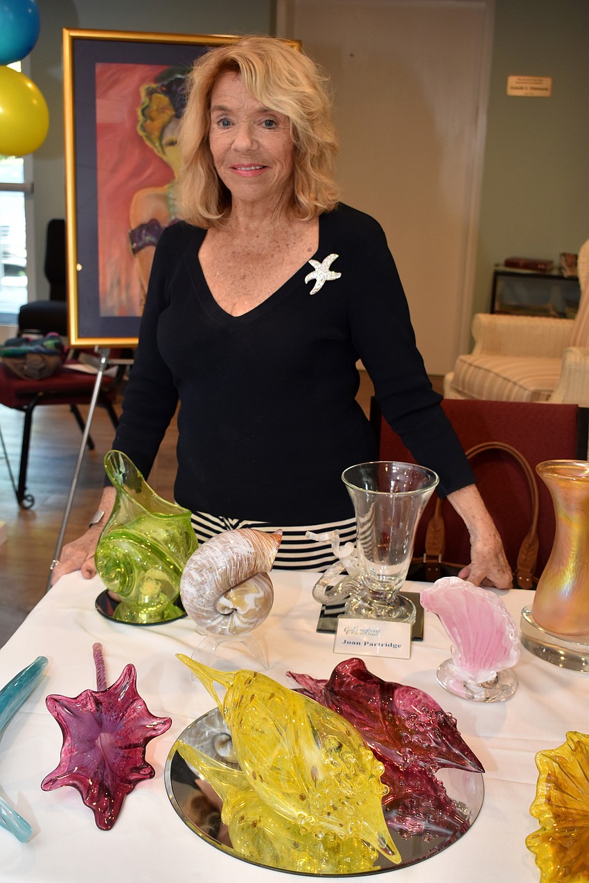 Joan Partridge displays her hand-blown glass collection.