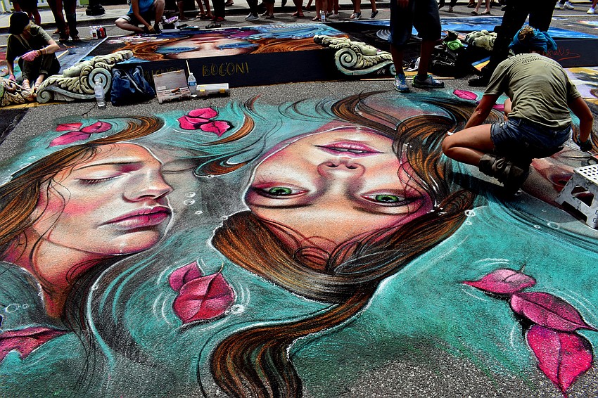 One artist put the finishing touches on her piece.