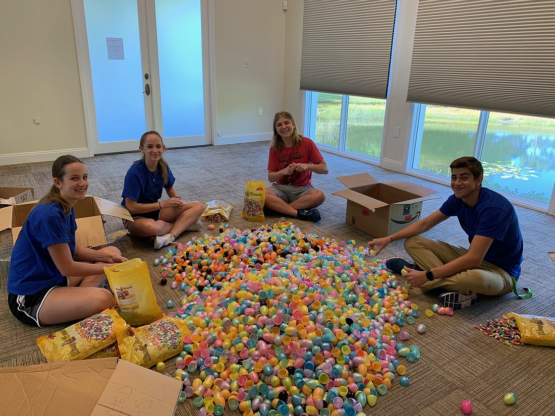 Lakewood Ranch High Key Club members Lindsey Hyer, Nicole Hyer, Lucas Scott and Connor Chapman volunteered to stuff plastic eggs for Eggstravaganza.