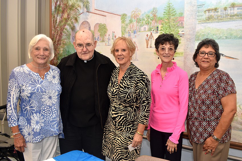 Officer Marilyn Bettencourt, Monsignor Gerry Finegan, officers Sue DiNatale, Paul Sharp and JoAnn Sifuentes