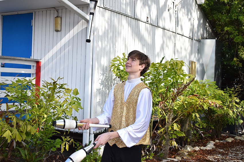 A Sailor Circus student juggles as guests enter the event.