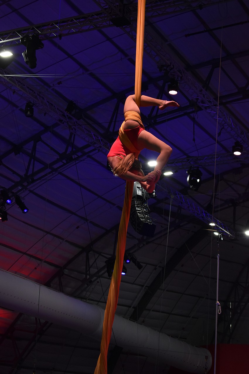 An aerial silks performer shows off the skills she learned from being a part of Sailor Circus.