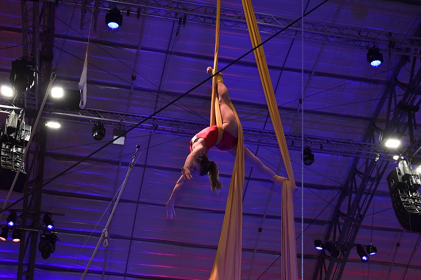An aerial silks performer shows off the skills she learned from being a part of Sailor Circus.
