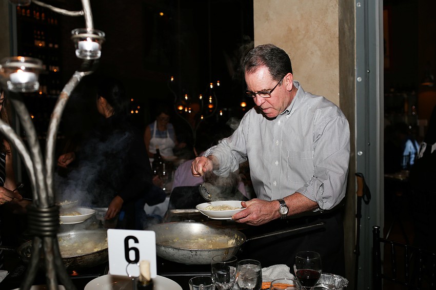 Shaun Maraman serves the dish to his table.