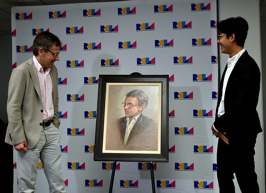 Ian Bremmer gets his first look at the portrait Ringling College of Art and Design senior Dionisius Mehaga Bangun Djayasaputra, or Dion MBD, created of him.