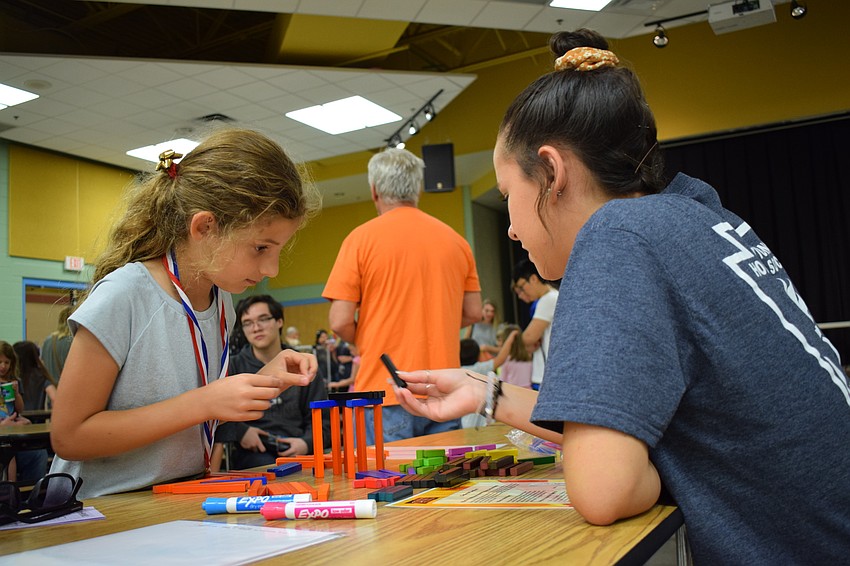 First grader Jasmin Gunhan builds with the help of volunteer and Lakewood Ranch High School junior Meghan Fitzpatrick.