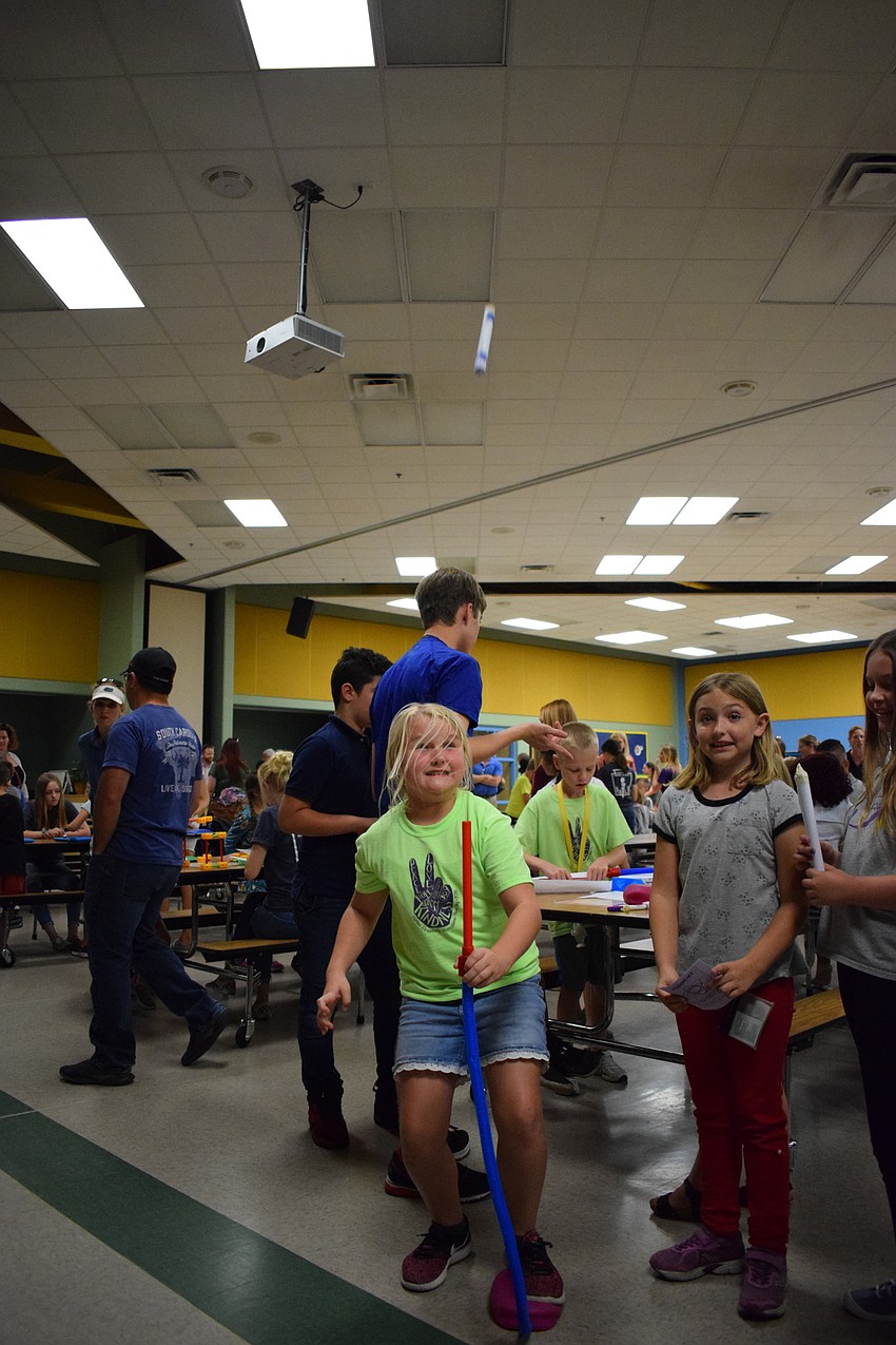 Sarah Overby, a third grader, watches her rocket shoot into the air while her friend, fellow third-grader Lorelei Miller, looks on.