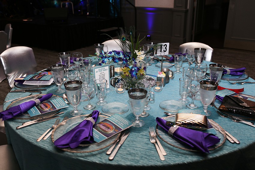 The tables were decorated in peacock colors.