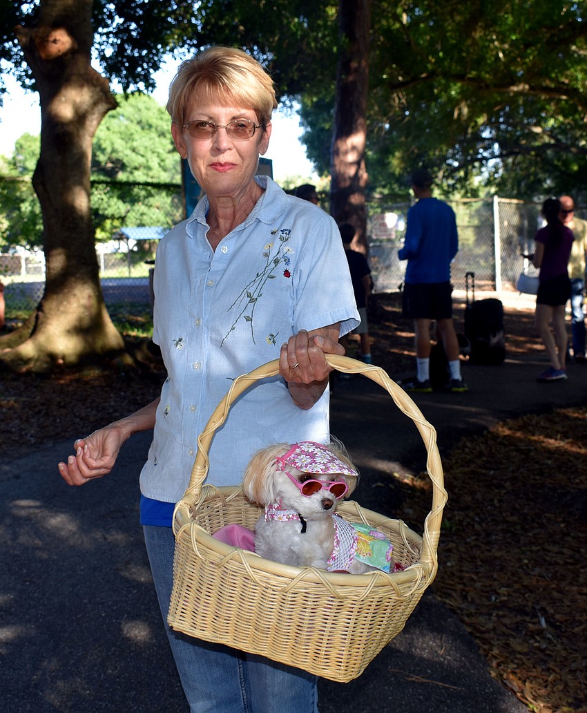 Nancy Roberts holds her dog Biscuit in an Easter basket.