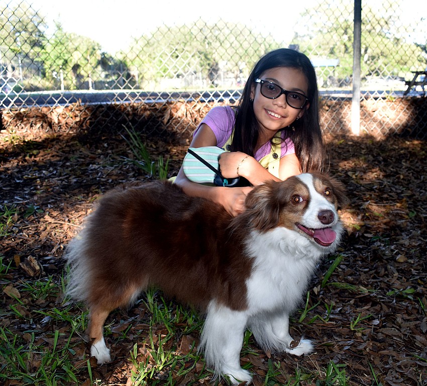 Mandy Alvarez hugs her dog Sara.