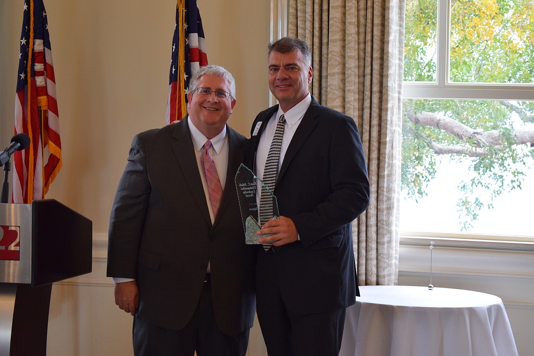 Leadership Manatee Alumni Association Treasurer Neil Unruh awards Doug Wagner with the 24th Annual Kent C. Schulz Distinguished Alumni Award.