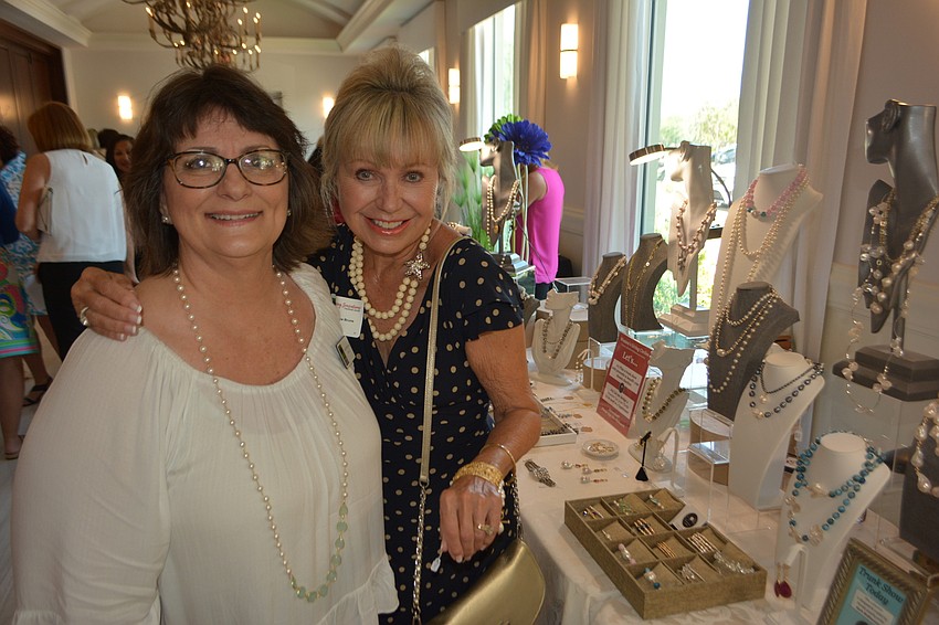 Barb McSweeney shows off her jewelry line to Sisterhood for Good's Diane Brune.