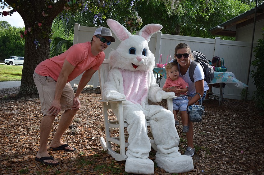 Colin Enos, of Braden Woods, crouches for a picture with the Easter Bunny alongside his wife, Gillian, and son, Jackson.