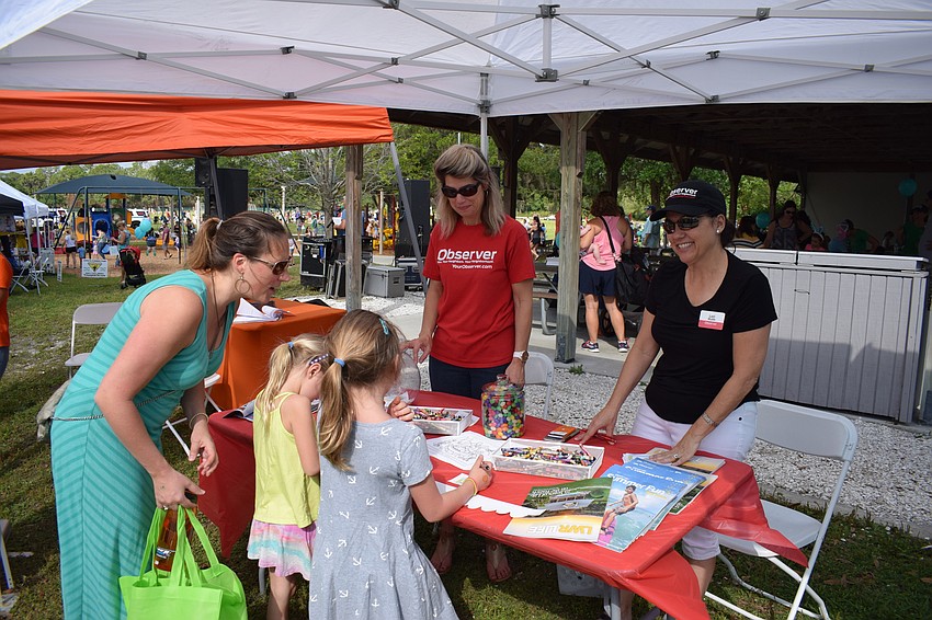 Observer Media Group's Toni Perren and Lori Ruth engaged with hundreds of guests who guessed at jellybeans and picked up coloring pages.
