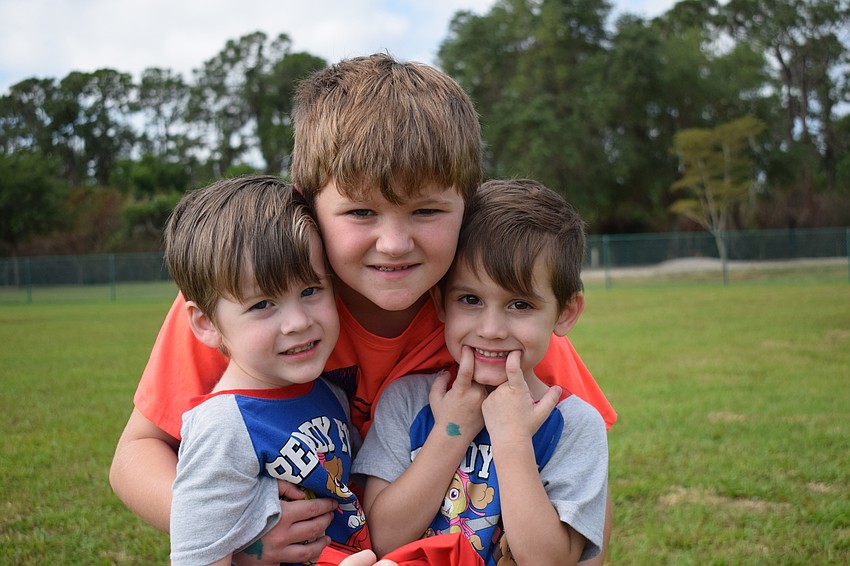 West Bradenton's Rex Templeton, Joseph Reeb and Milo Templeton grin in excitement.