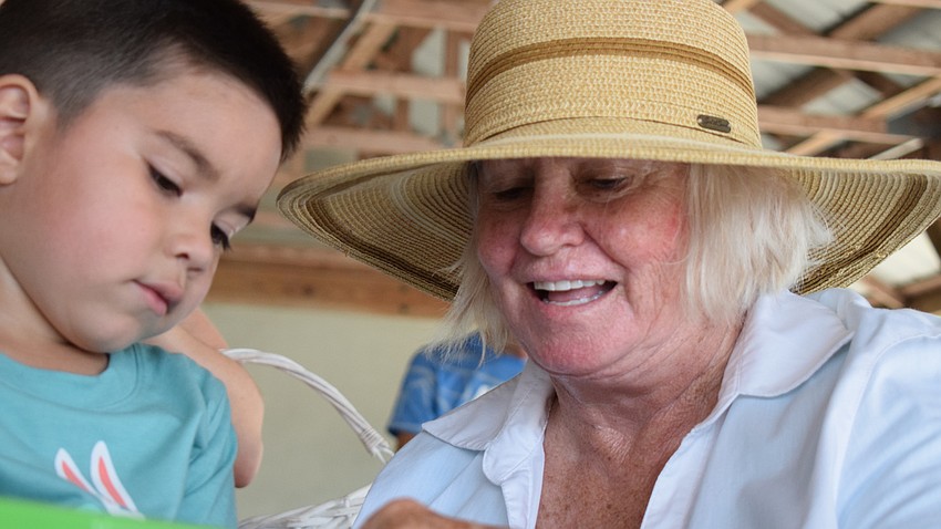 Volunteer Ann Trick (right) helps Lakewood Ranch resident Gunner Muth, 4,with arts and crafts.