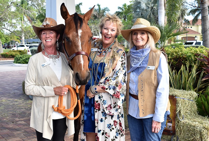 Event chairwoman Carol Patulo, Tami Walsh and Carolyn Bruder with Peppy the horse