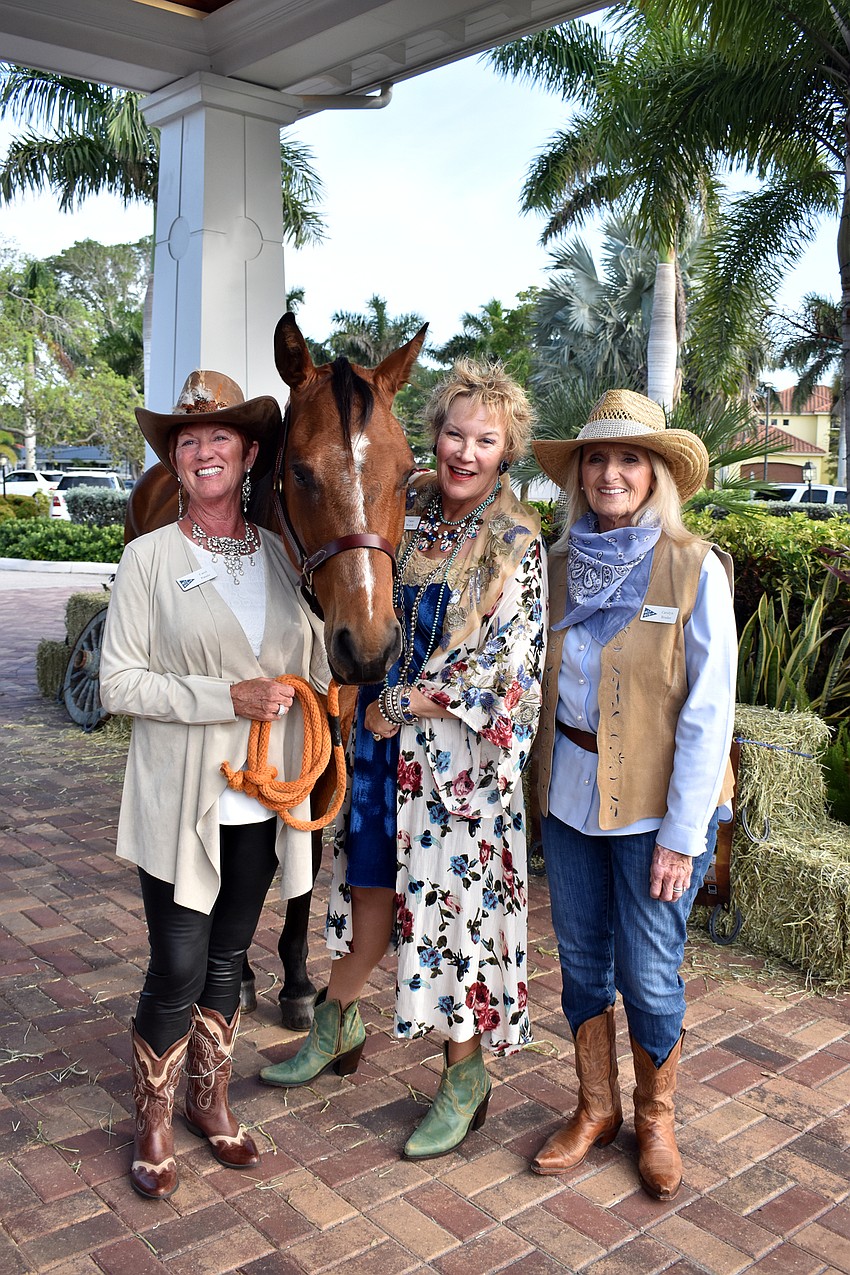 Event chairwoman Carol Patulo, Tami Walsh and Carolyn Bruder with Peppy the horse