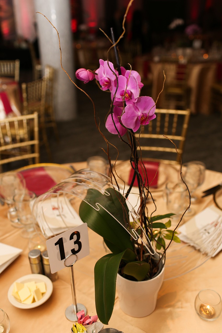 Orchids in multiple colored centered the tables.