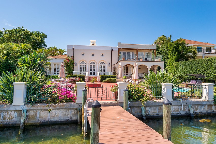 The home features a dock that connects to Sarasota Bay.