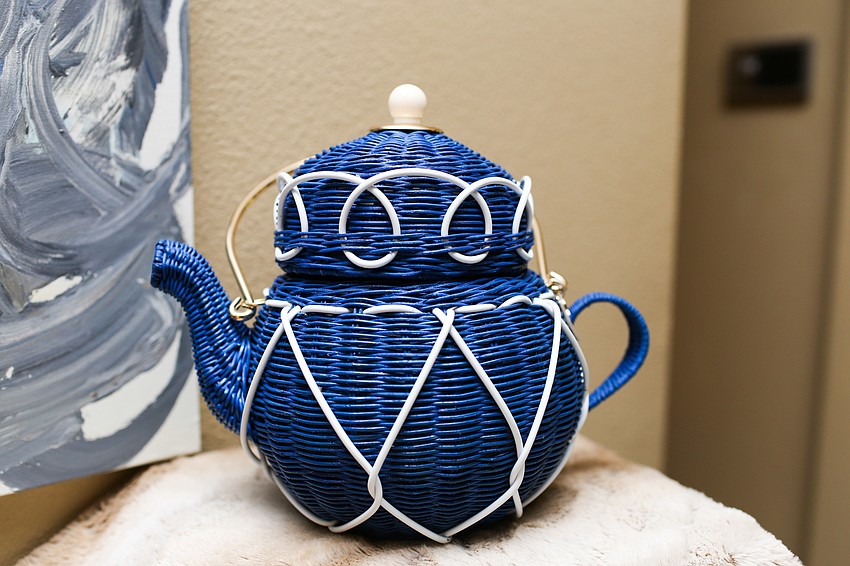 Phillips sported this teacup Kate Spade purse at The Concession Golf Club’s Mother’s Day Brunch.