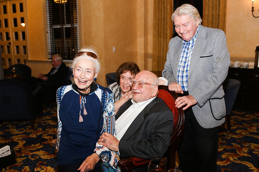 Eva Slane sits on Ed Asner's lap for a photo.