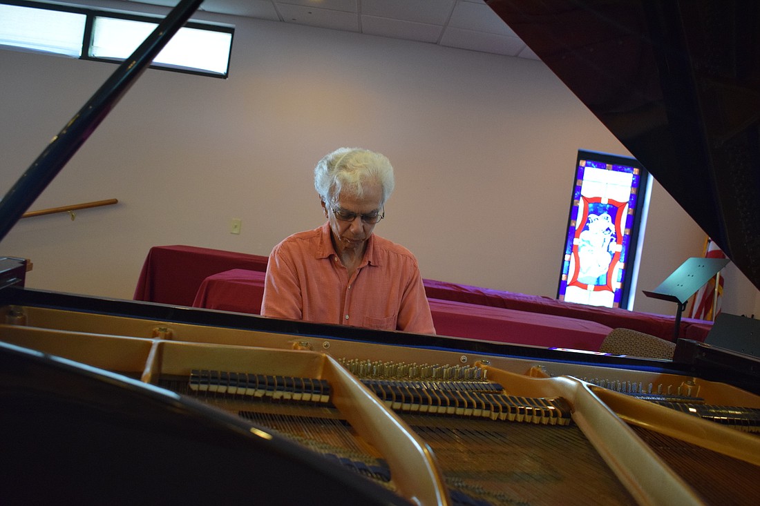 Thomas Pizzi plays the grand piano he&#39;ll use during his performance at the April 27 concert.