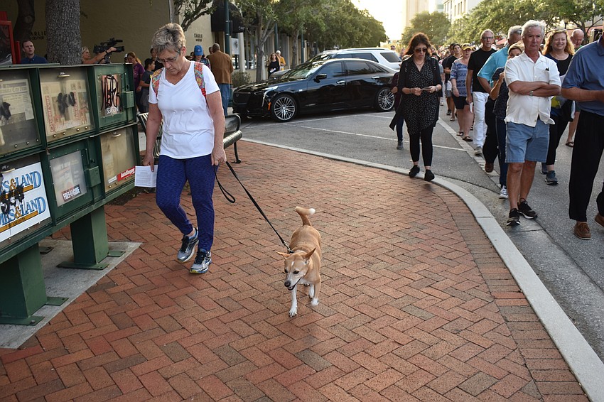 Christin Whacker and her dog, Piper, follow along with the crowd.