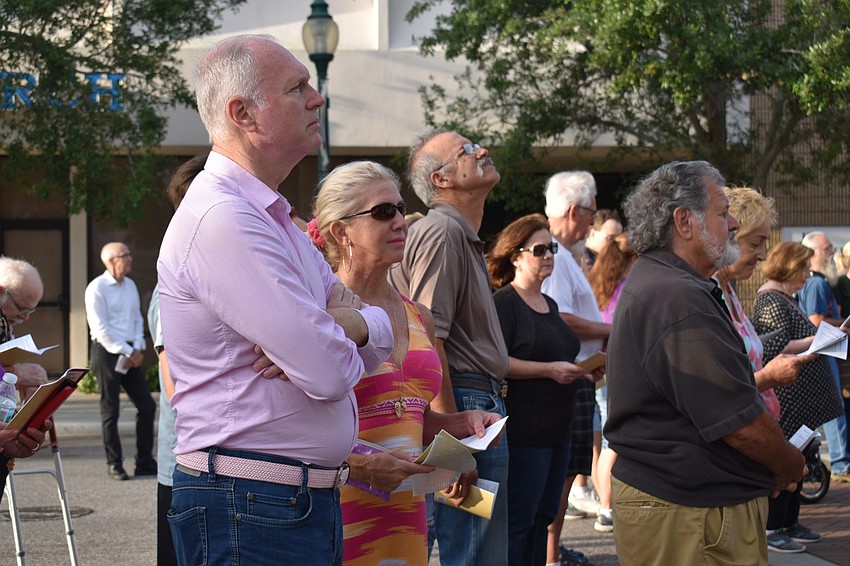 Harold Freeman and Sherri Vroom share a book during the sixth station.