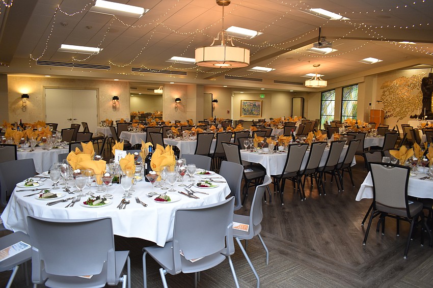 The tables were decorated with a touch of gold and the room was decorated with lights.