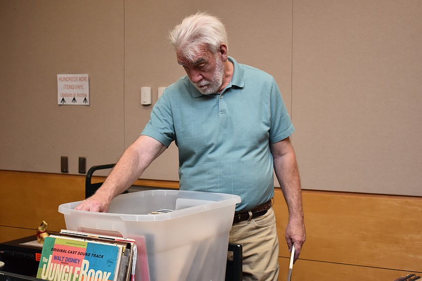 James Fogel flips through the records, some of which are rare, according to David Berry, the manager of the Sarasota Musical Archive.