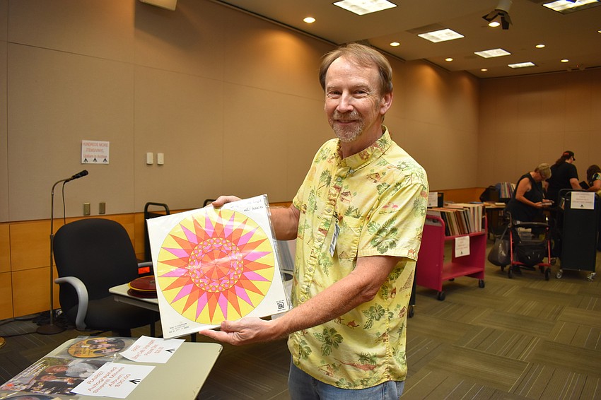 David Berry holds up one of the records on sale.