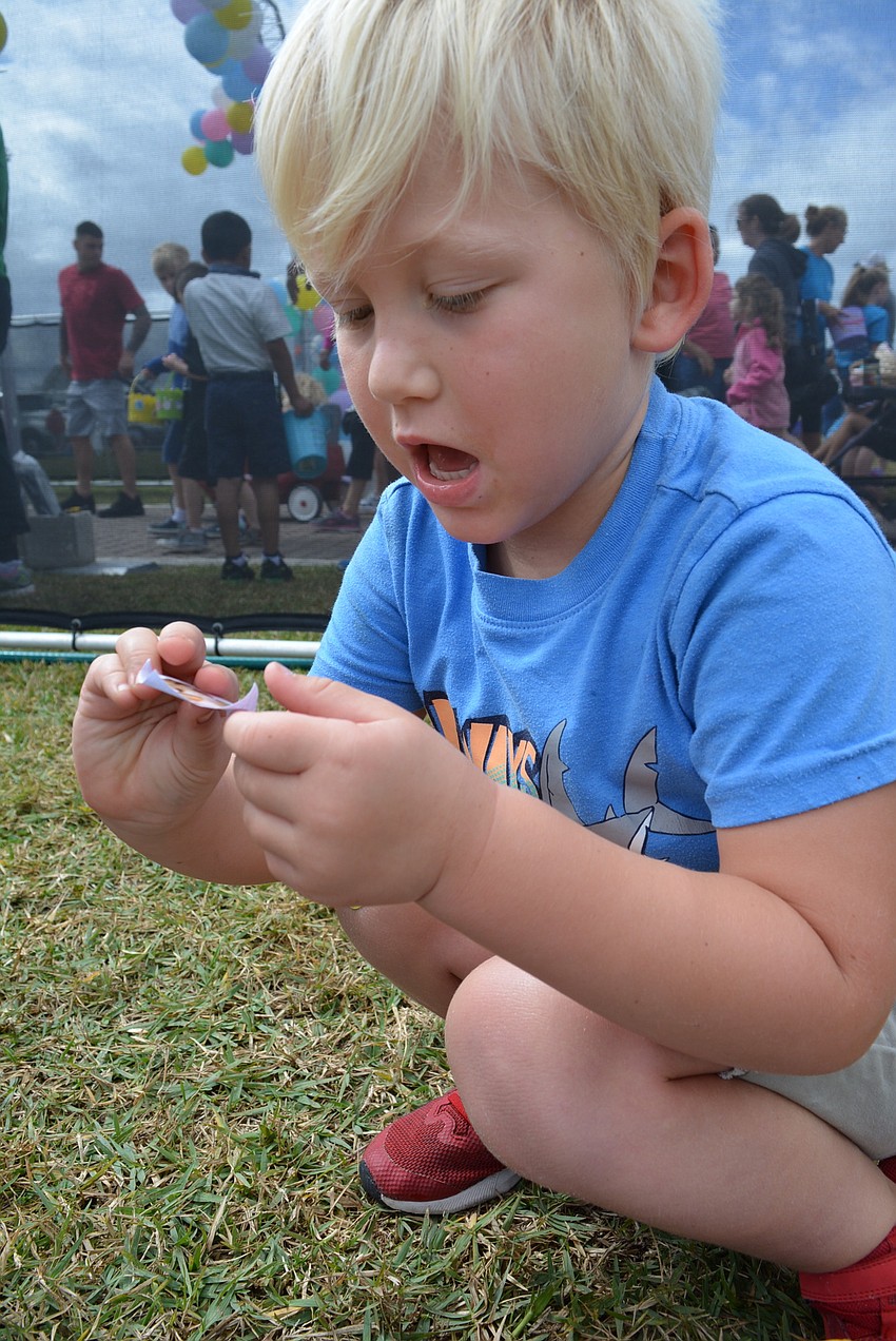 Four-year-old Roary Longley, of Osprey, checks out the stickers inside his eggs. He said he was more excited about the trucks than the egg hunt.