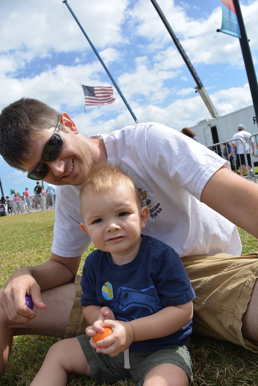 One-year-old Luke Bevill, with his father, Brian Bevill, is thrilled to get a sticker of his favorite animal, a turtle.
