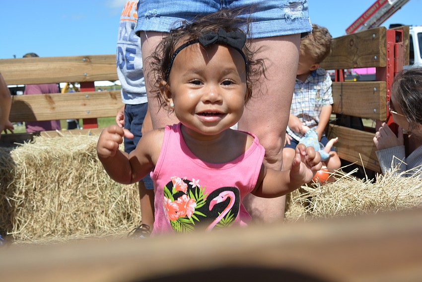 One-year-old Mila Bryant loves seeing all the trucks from a hayride seat. She was visiting her grandparents from out of town.