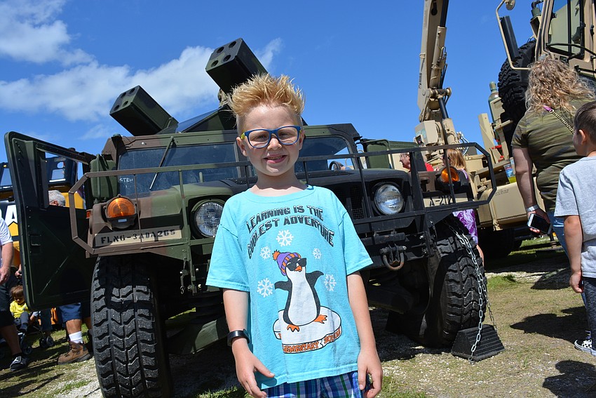 Parrish 8-year-old Evan Fulton makes sure to pose with a military vehicle.