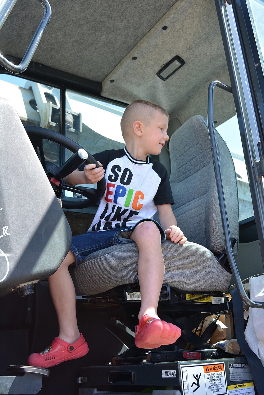 Five-year-old Dennis Lloyd, of Sarasota, likes hearing all the different sounds the horns make.