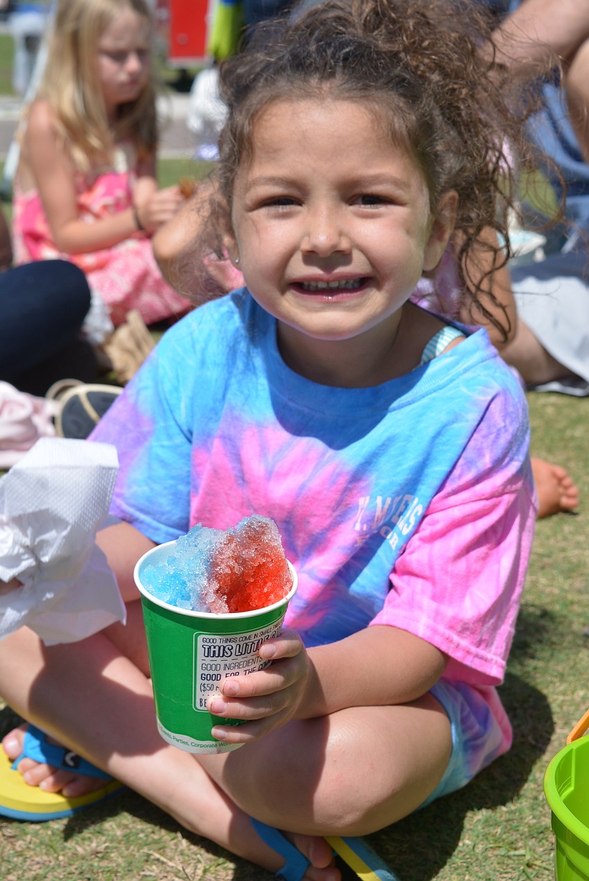 Five-year-old Mila Saenz and her family enjoyed snow cones with the Frost family, from Lakewood Ranch. Mila was visiting them from Illinois.