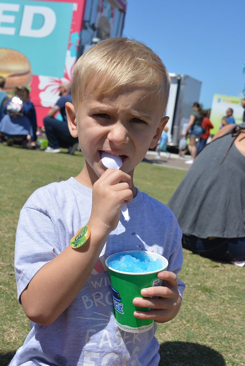 Four-year-old Lakewood Ranch resident Preston Frost enjoys a snow cone with family and friends after a successful egg hunt.