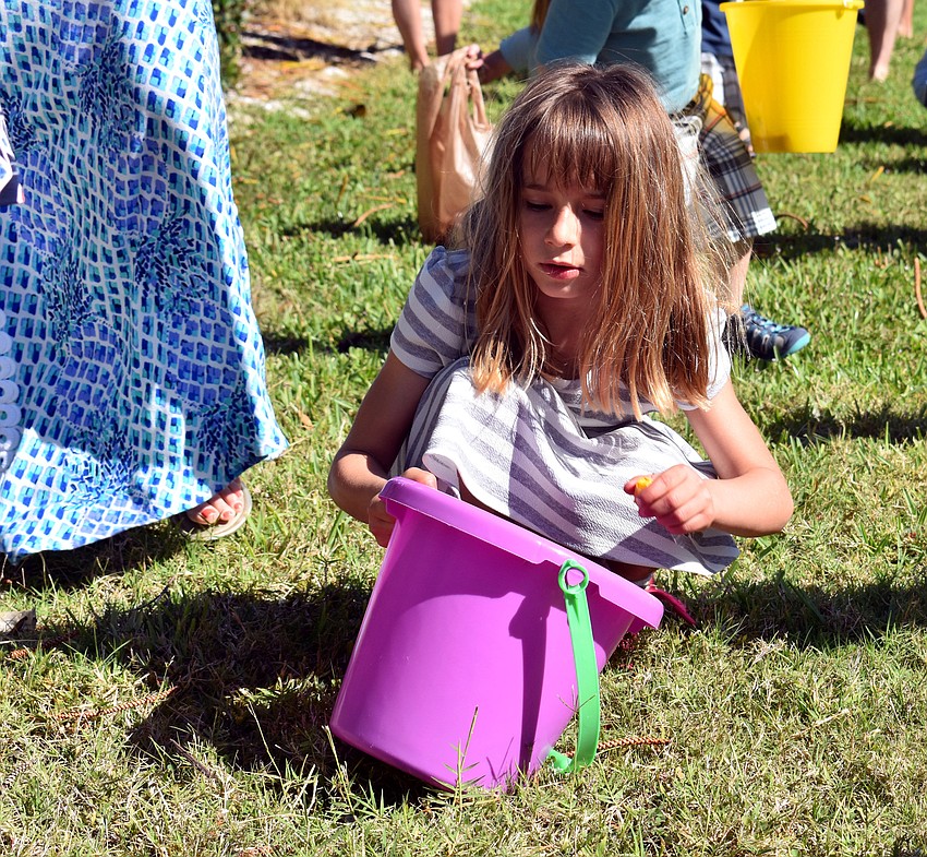 Reese Rolfes scoops up candy.