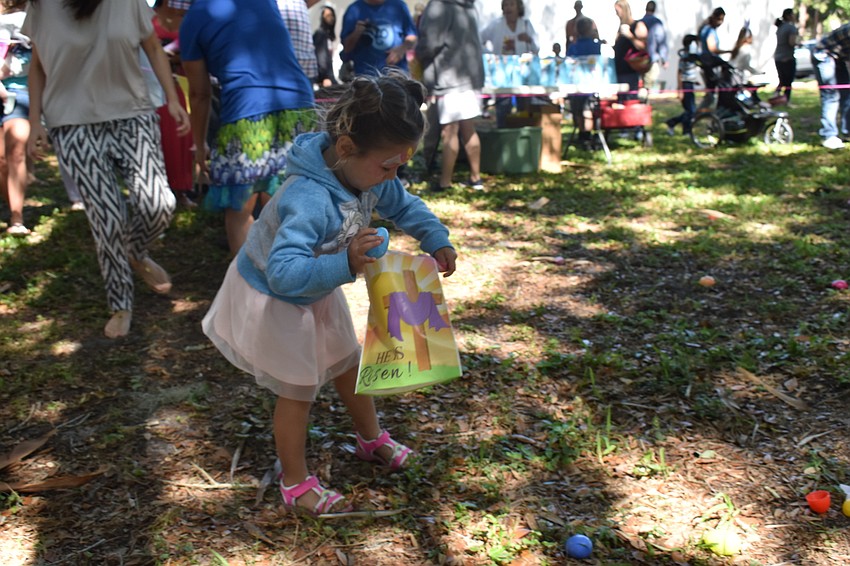 Elle Carino grabs her first egg of the hunt.