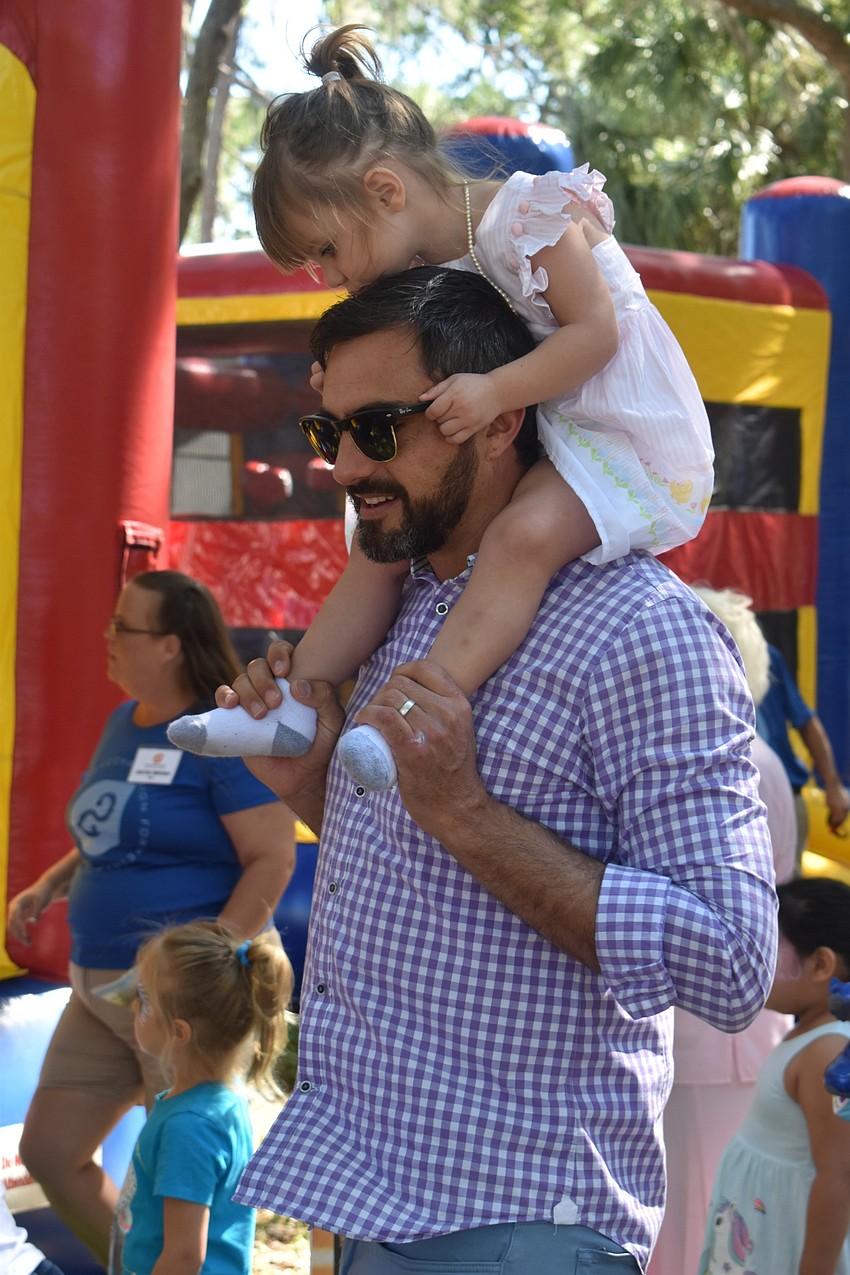 Ricky Perrone carried his daughter, Capri Perrone, around on his shoulders.