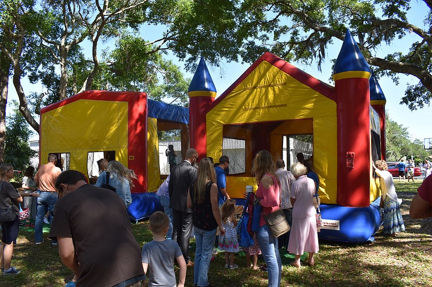 There were three bouncy houses for the children to use.