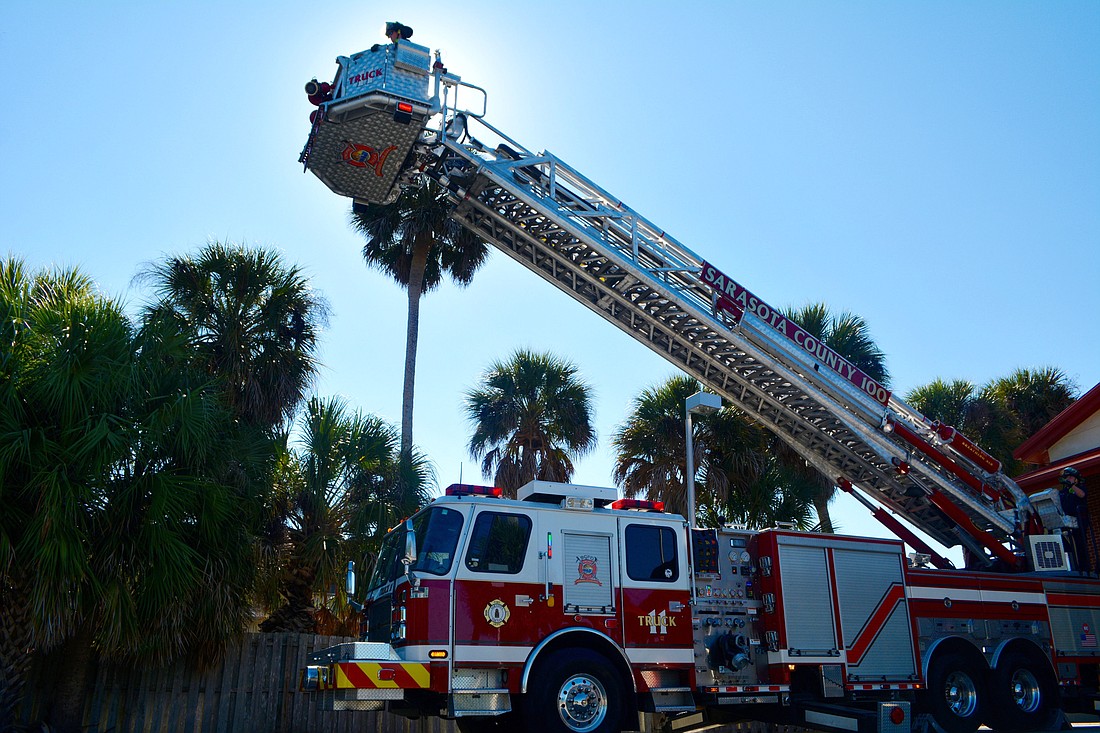 The fire truck at Station 11 raises extends its ladder in a demonstration of its capabilities.