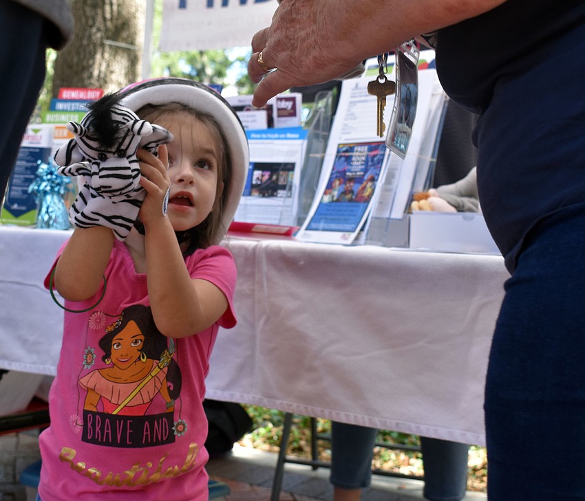 Two-year-old Serenity Rickman shows off her zebra puppet.