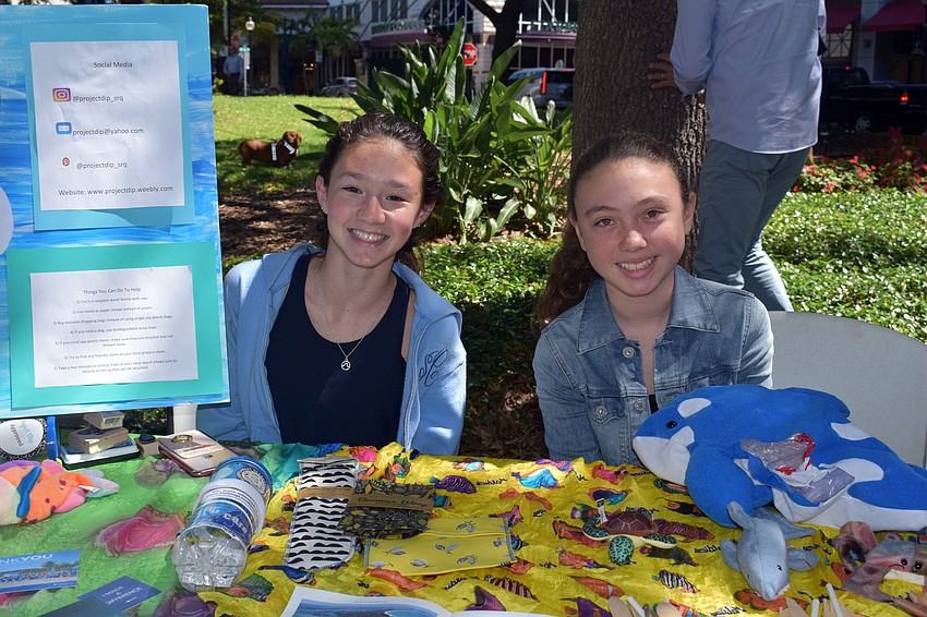 Sadie Chawkins and Gemma Davies set up a table with their community service project, Dip, which focuses on the effects plastics have on an ecosystem.