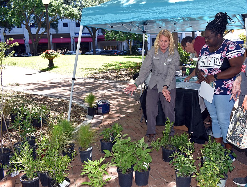 Perdonika Monlyn carefully selects a plant that will thrive in her home.